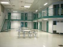 Dayrooms are large common areas where the inmates can watch T.V., play card or board games, talk on the telephones or have a visit on one of the visiting monitors.