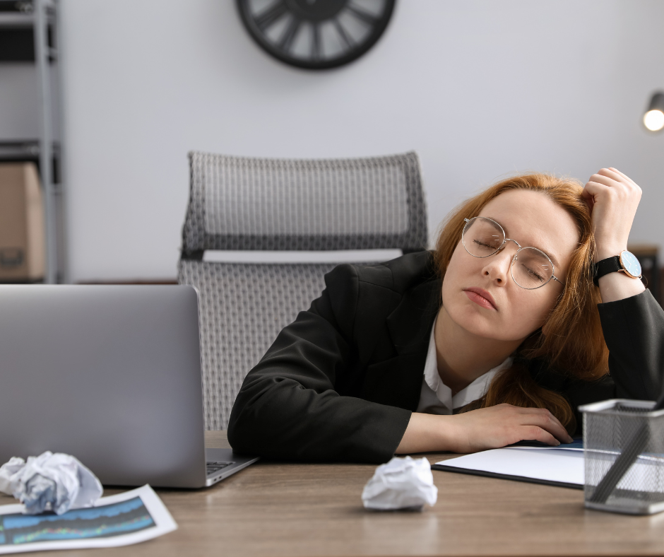 Woman falling asleep at her desk